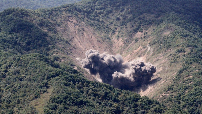 Bombs explode in the hills on the peninsula.