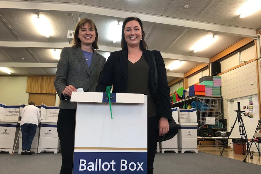 Joanna Siekja (r) casts her vote in Pembroke with Julie Collins