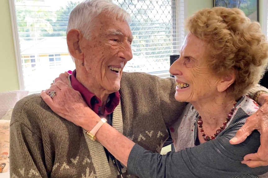 Older couple hug, smile, laugh looking at each other