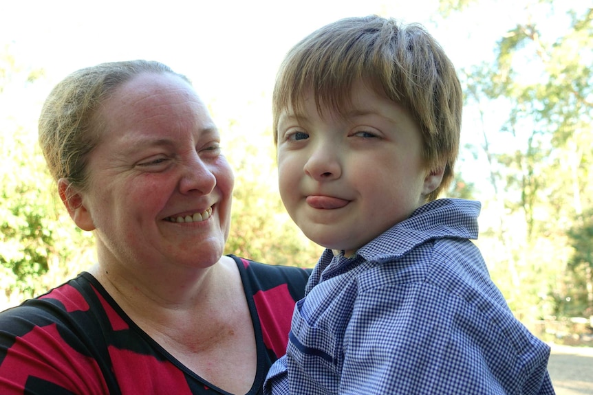 Sue Tape and her daughter Eliza, both smiling and looking at the camera.