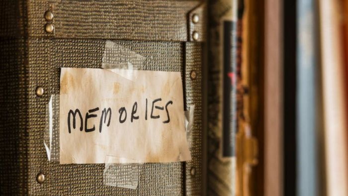 The word memories written on a box sitting on a bookshelf