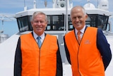 Mid shot of Colin Barnaett and Malcolm Turnbull standing on the deck of a boat.