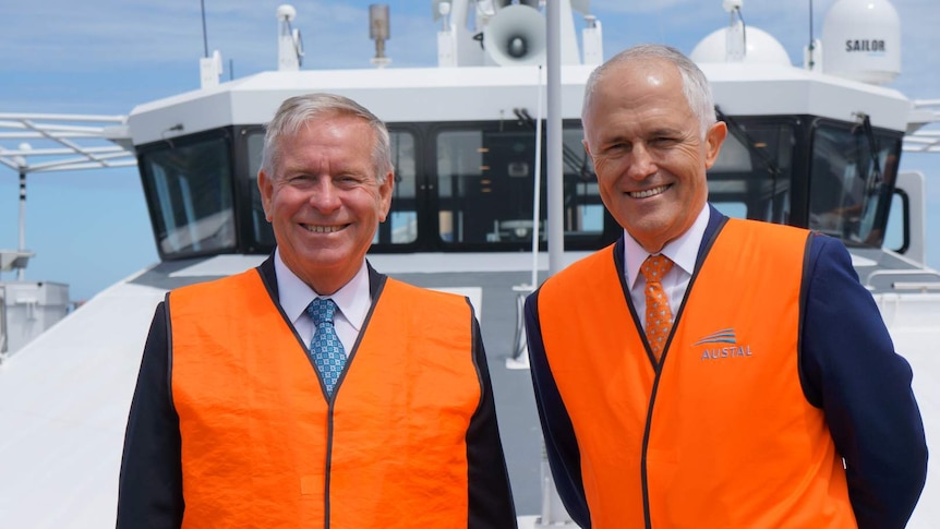 Mid shot of Colin Barnaett and Malcolm Turnbull standing on the deck of a boat.
