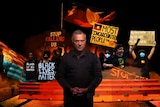 Stan Grant stands in front of Black Lives Matter protesters.