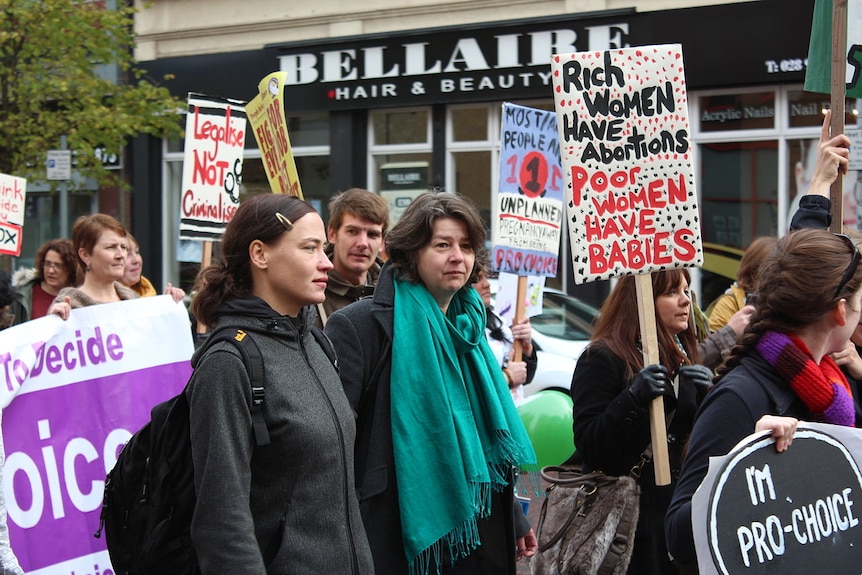 You see a crowd of people holding pro-abortion placards.