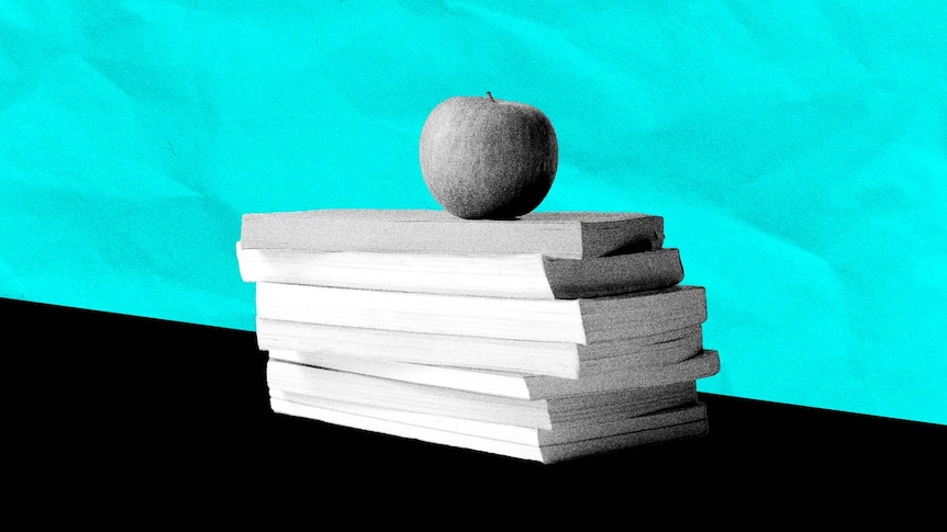 Black foreground with pile of books and an apple and a bright blue background with paper crinkle texture