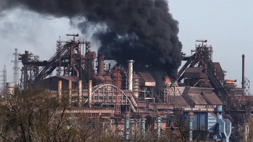 Smoke rises above a plant of Azovstal Iron and Steel Works.