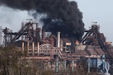 Smoke rises above a plant of Azovstal Iron and Steel Works.
