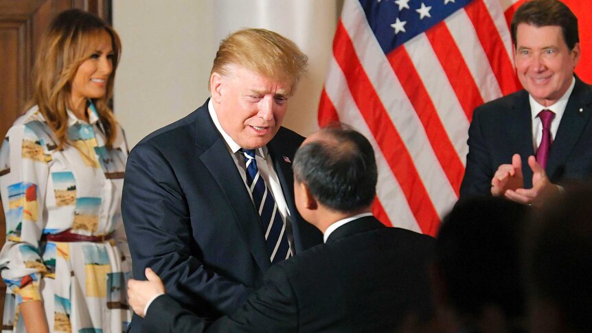 Donald Trump greets Masayoshi Son