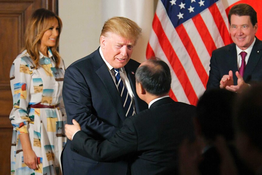 Donald Trump greets Masayoshi Son