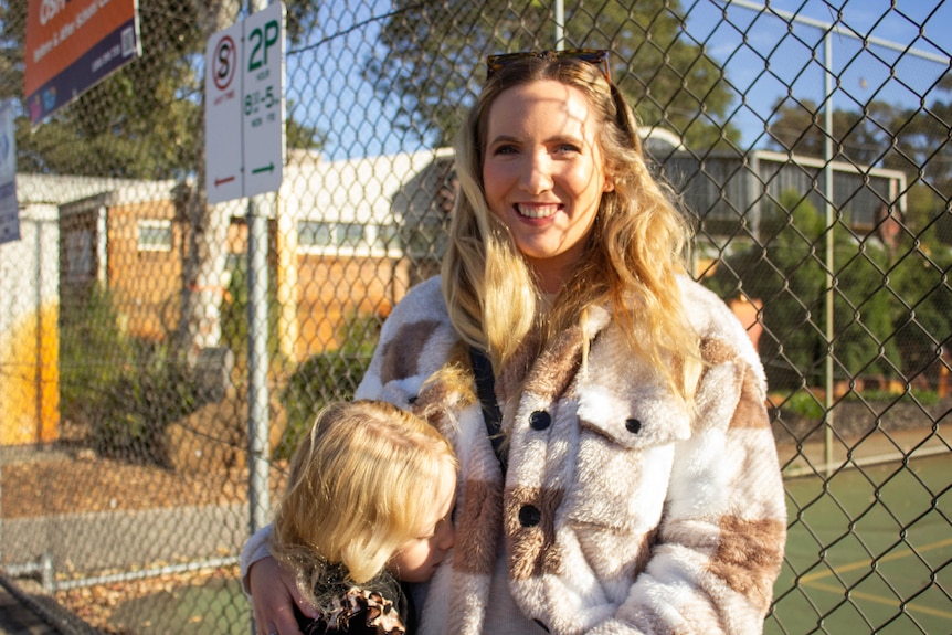 Lucy Ramm in jacket with her child.