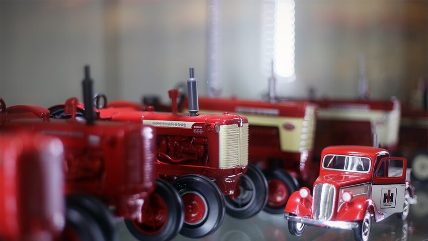 A collectable Case International tractor sits on a shelf among hundreds of other model tractors.