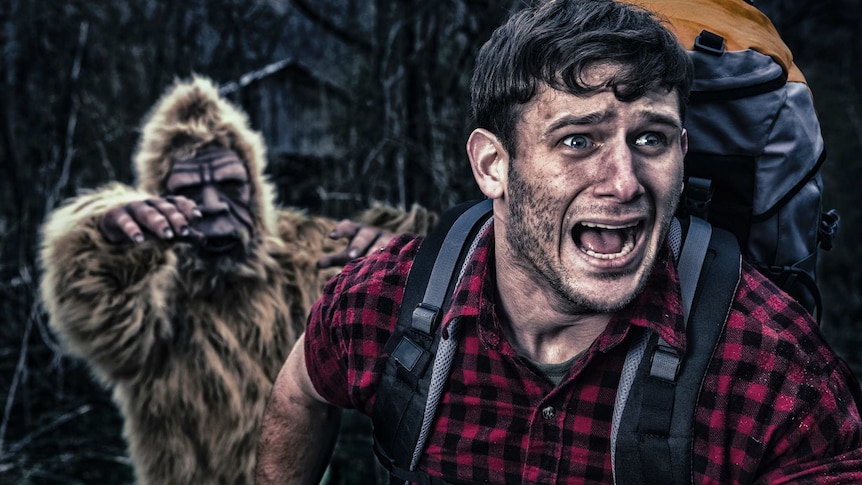 A screaming man runs from a hairy bigfoot, chasing him with arms outstretched