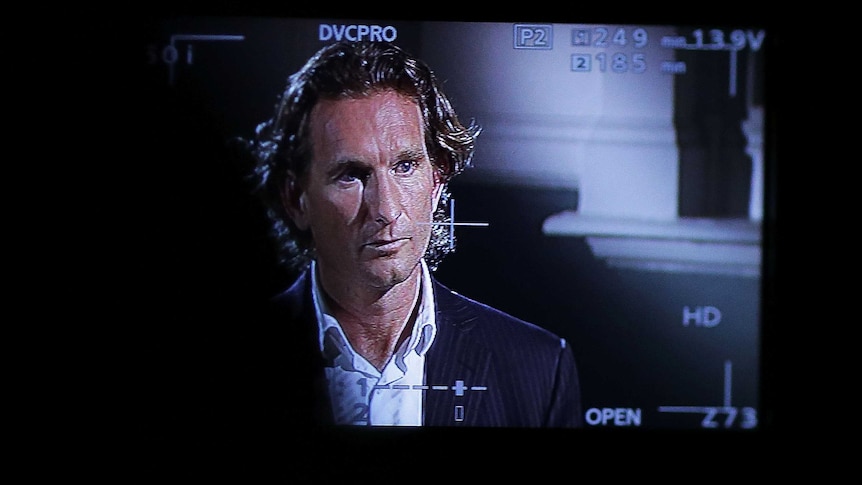 James Hird seen through a camera