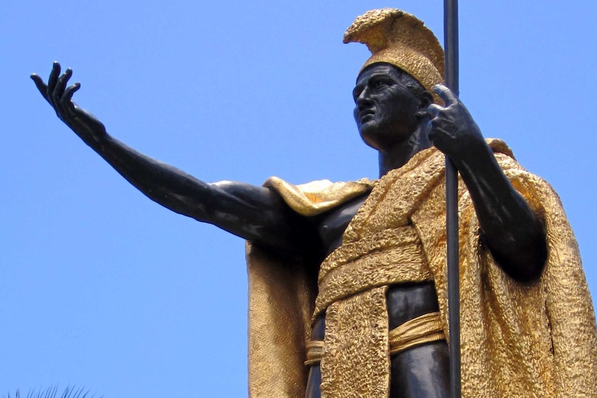 A statue of King Kamehameha dressed in a gold cloak.