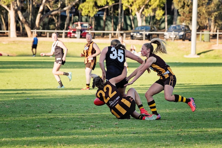 Players during a suburban Australian rules football game.