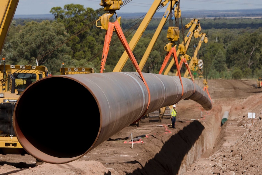 QCH coal seam gas pipeline goes into the ground near Chinchilla in southern Queensland in 2014.