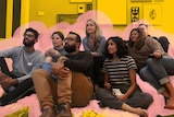 Group of men and women sitting in a living room and watching TV for a story about Game of Thrones ending and its community.