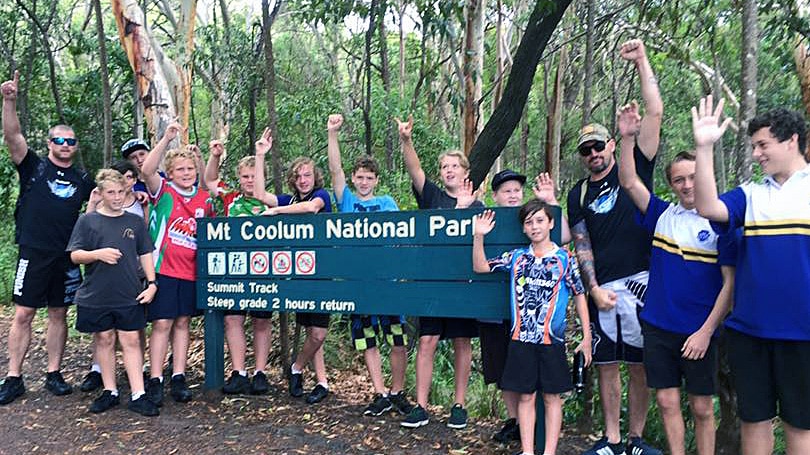 youths and group leaders at national park sign