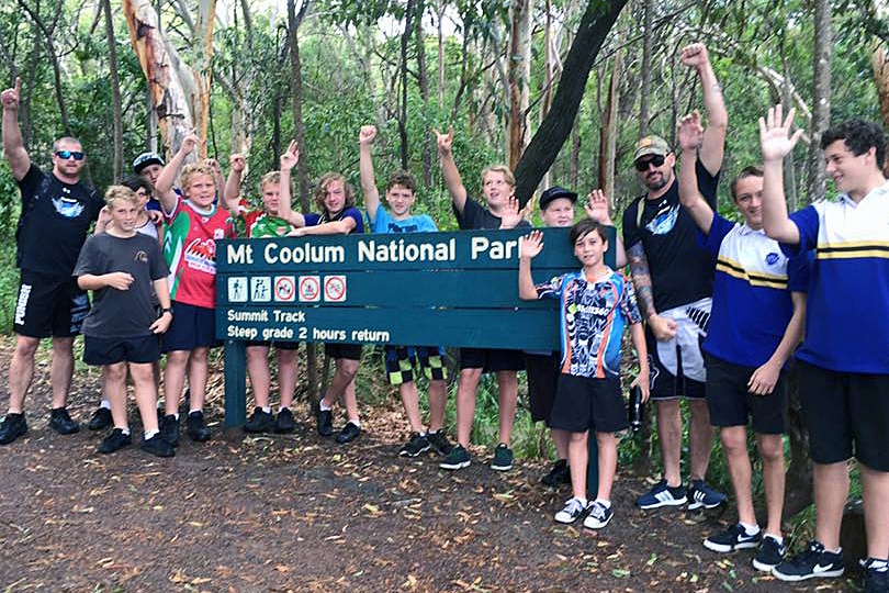 youths and group leaders at national park sign