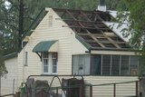 Winds of up to 130kph tore through St George in the state's south-west, taking the roofs off houses.