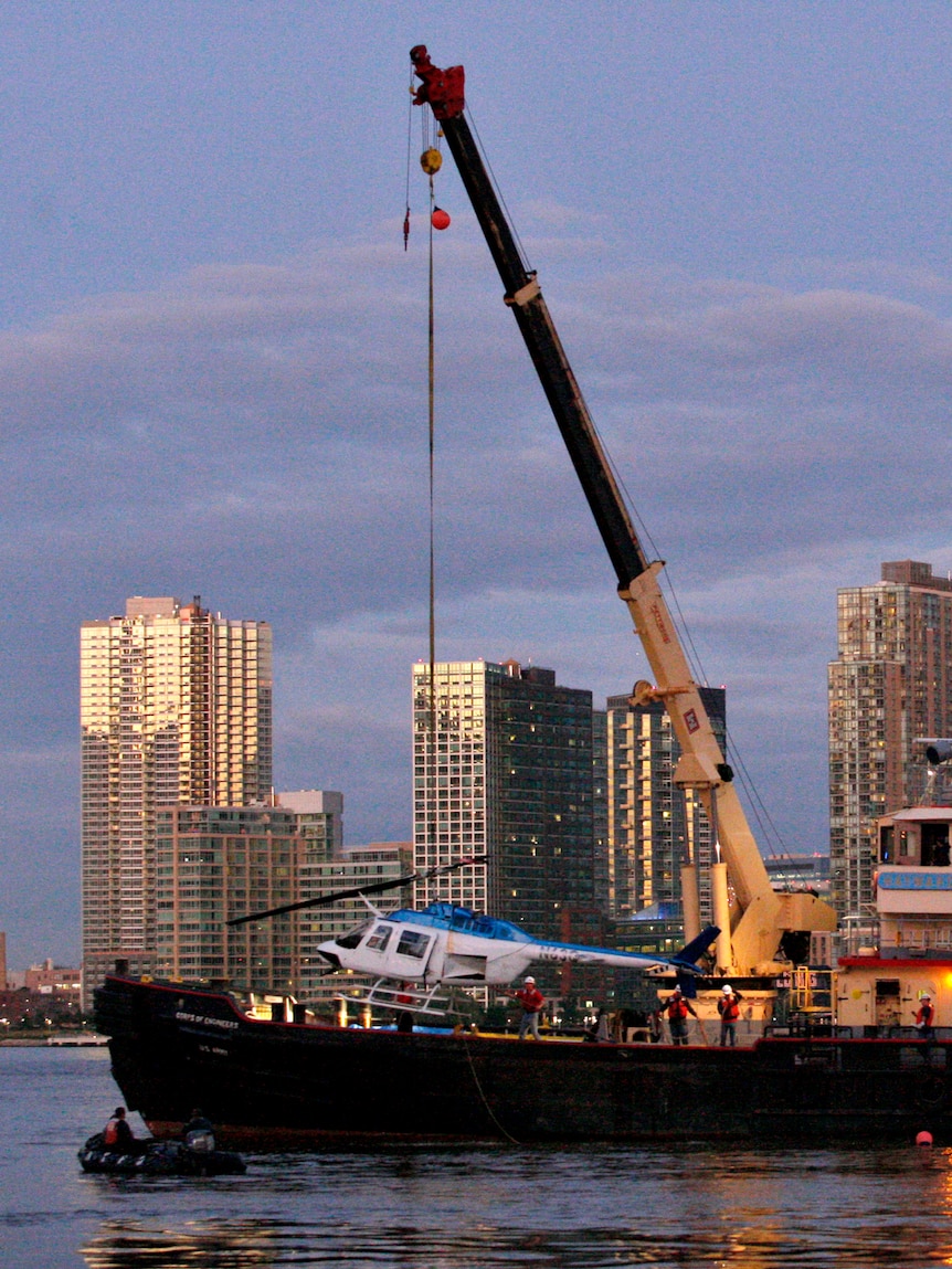 The crashed helicopter is hoisted from the water in New York October 4, 2011.