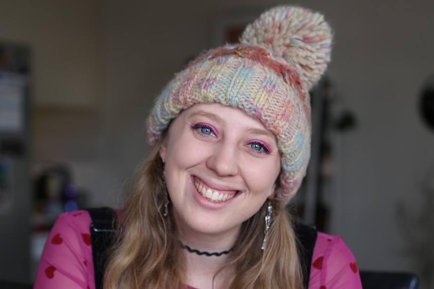 portrait shot of Grace smiling with beanie on