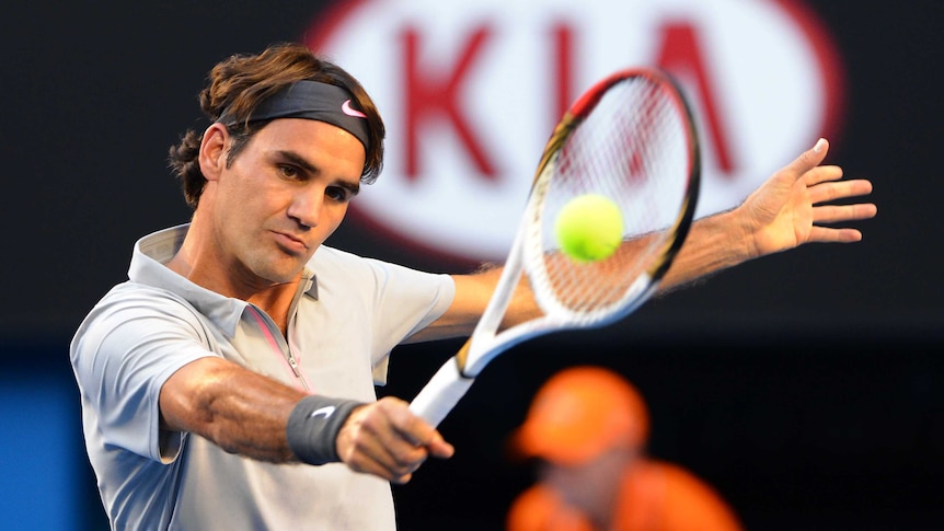 Roger Federer plays a backhand against Nikolay Davydenko at the Australian Open.
