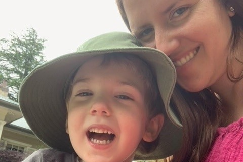 A woman and a boy smiling. 