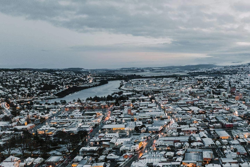 An aerial shot of a city covered in snow