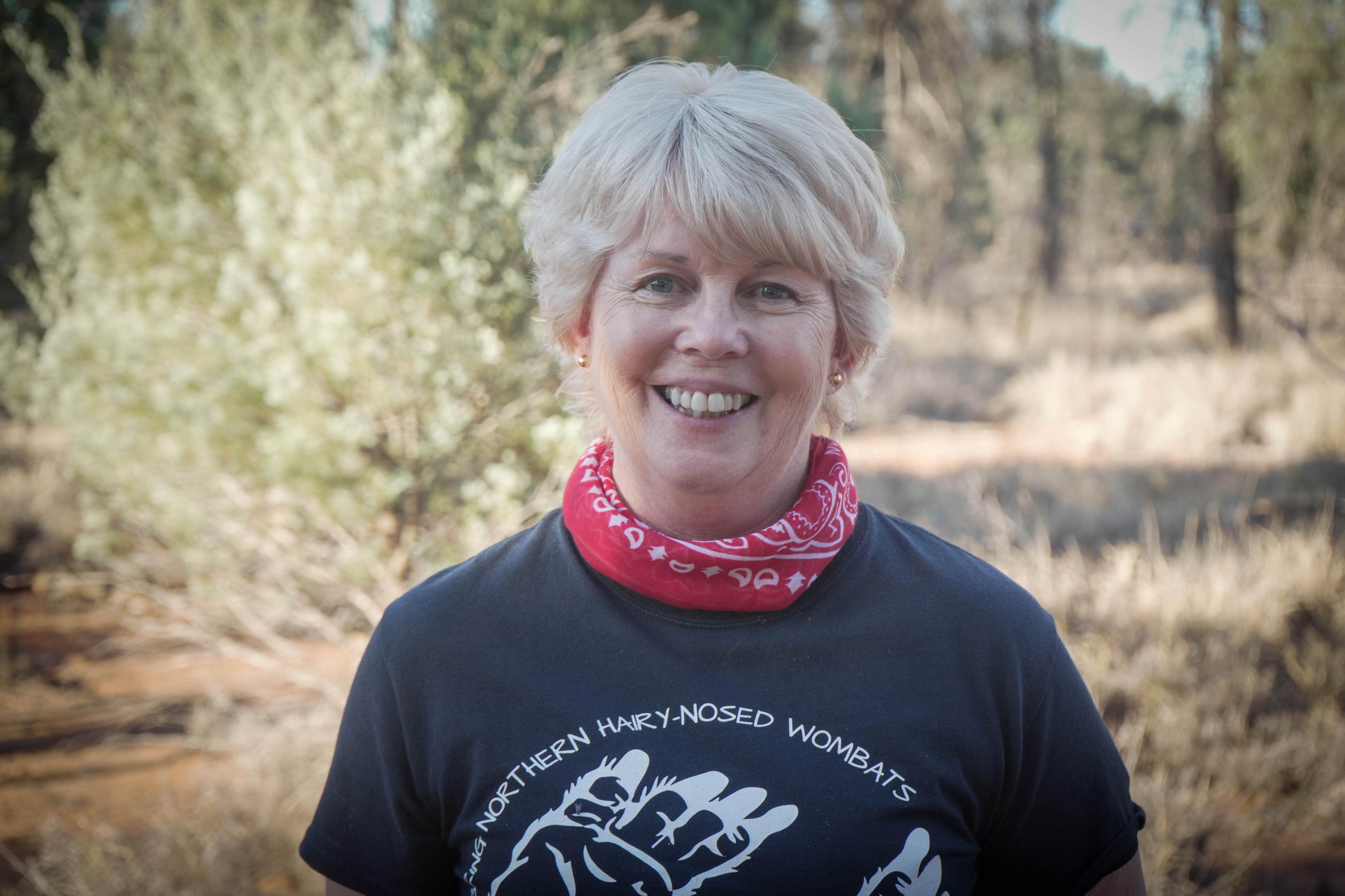 A woman smiles while standing in bushland in southern Queensland.