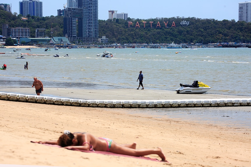 A woman lies on the beach