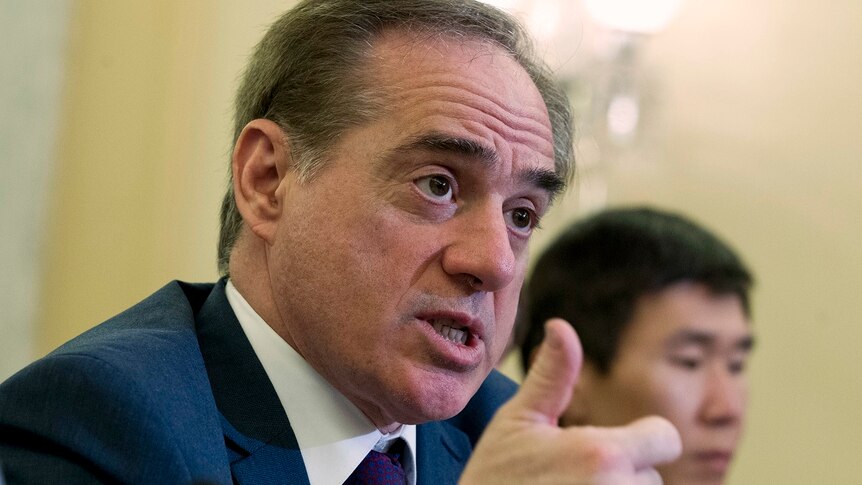 A close up of Veterans Affairs Secretary David Shulkin speaking with his thumb up