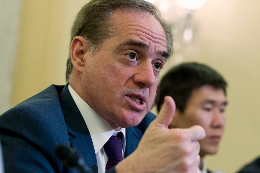 A close up of Veterans Affairs Secretary David Shulkin speaking with his thumb up