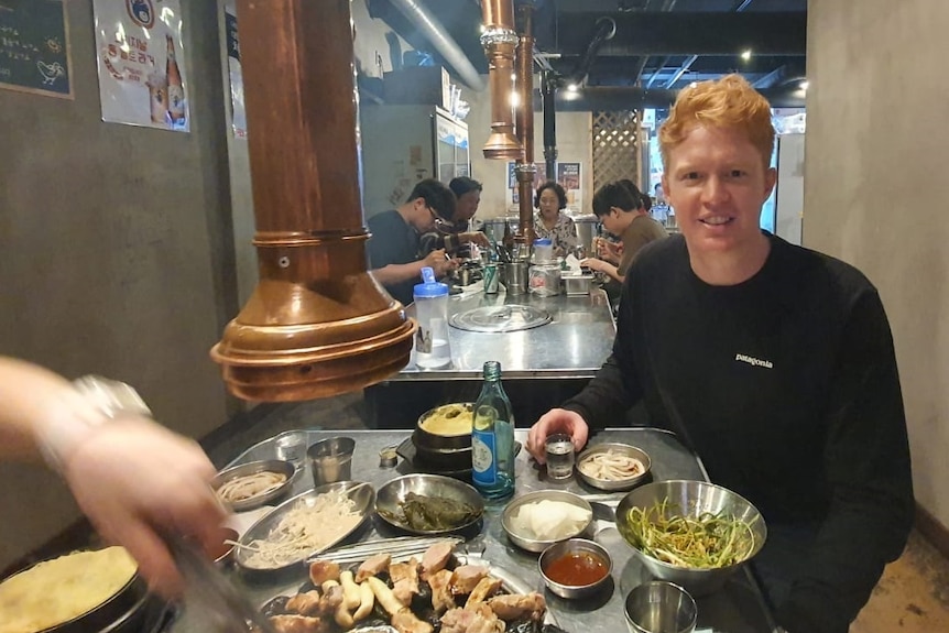 Australian expat Tim Forrester enjoys a meal at a restaurant in Suwon, South Korea, on Friday night.
