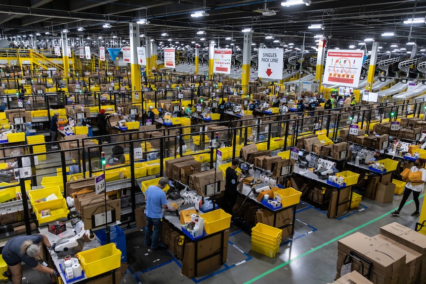 A giant warehouse where hundreds of workers process orders.