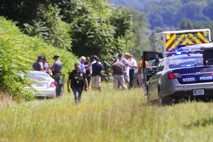 Police surround the car of Vester L Flanagan.