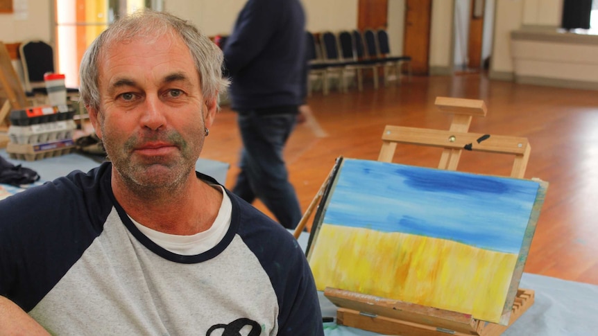 Mark Beswick with his painting as part of the rehabilitation art classes