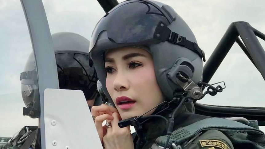 Sineenat Wongvajirapakdii in a helmet and uniform flying a fighter jet.