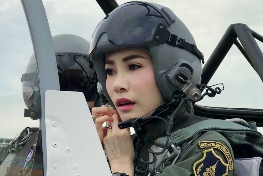 Sineenat Wongvajirapakdii in a helmet and uniform flying a fighter jet.