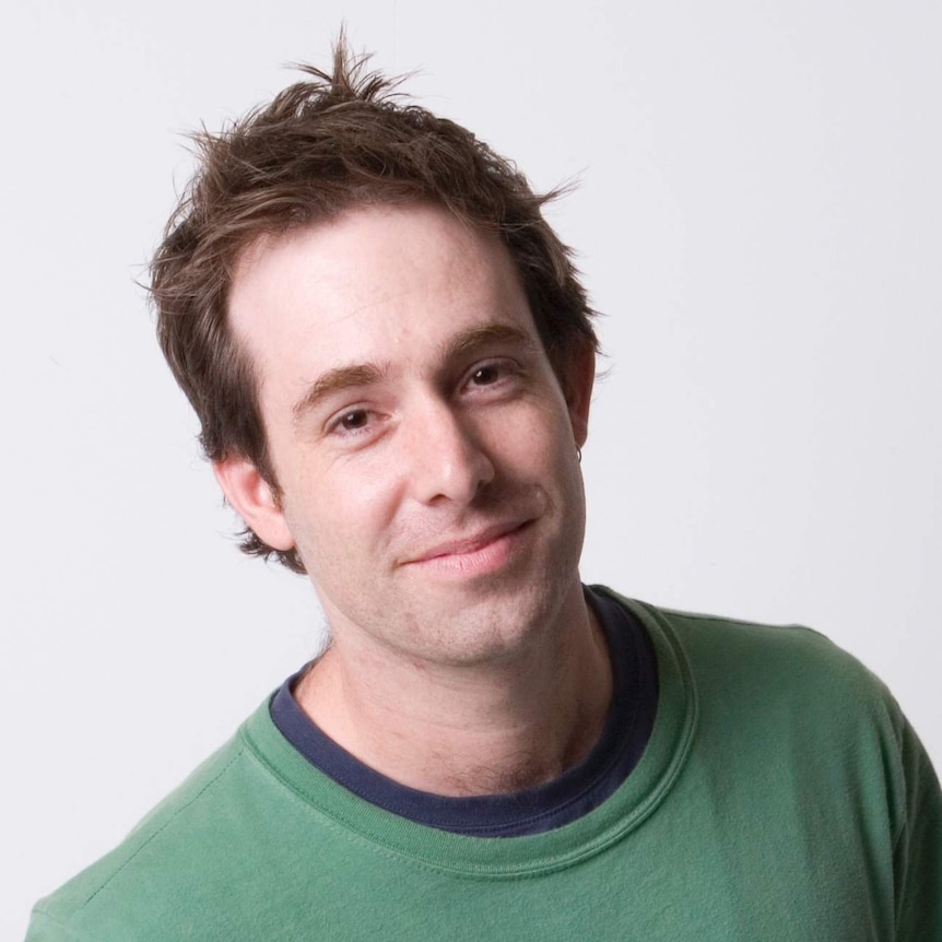 Australian songwriter Phil Barton wearing a green shirt and smiling at the camera.