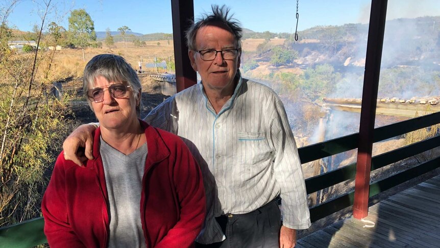 Dianne and Vince Hollis standson the veranda of their home after bushfire damaged a rail bridge.