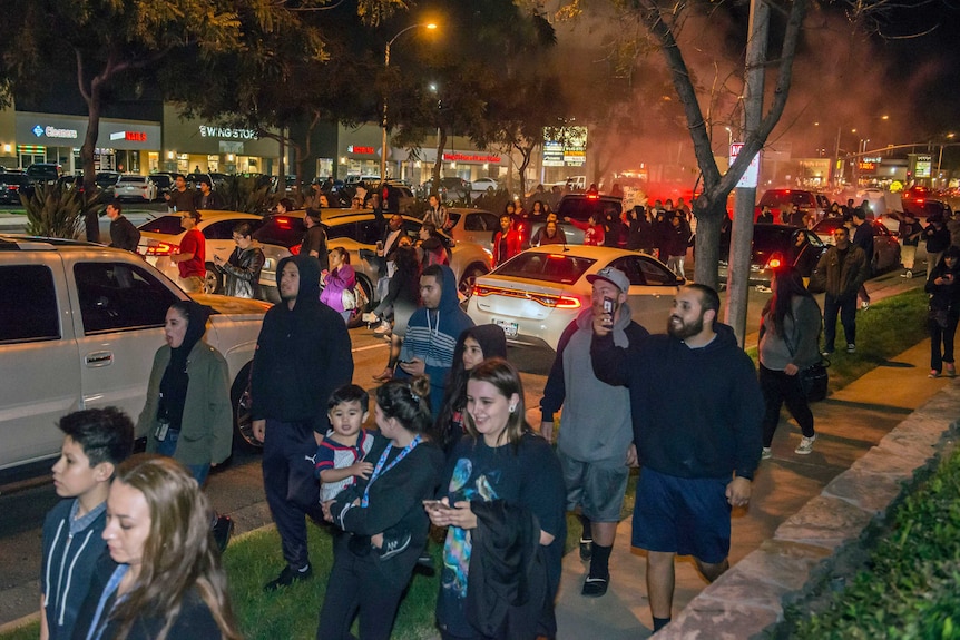 People protest in Anaheim, Los Angeles, after a video emerged appearing to show an off-duty police officer firing a single round during a tussle with a 13-year-old boy. February 23, 2017.