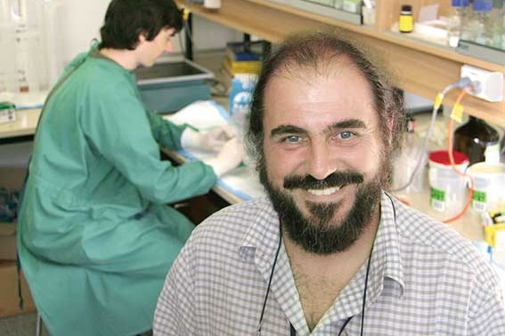 Man with beard smiles in the lab