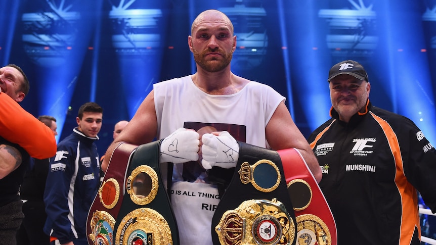 Tyson Fury holds four world heavyweight title belts after beating Wladimir Klitschko in Duesseldorf.