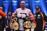 Tyson Fury holds four world heavyweight title belts after beating Wladimir Klitschko in Duesseldorf.