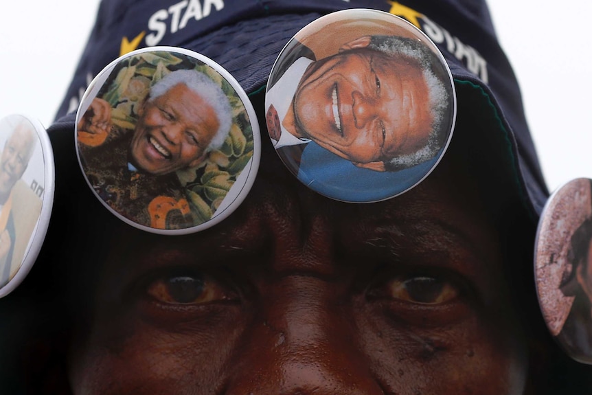 Street vendor with Mandela pins