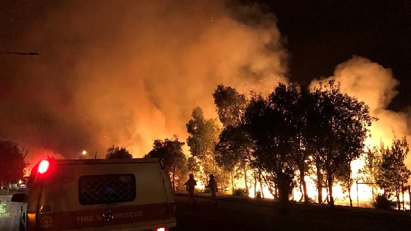 Firefighters battle the blaze, which was due to impact Coolum Beach about 7:30pm.