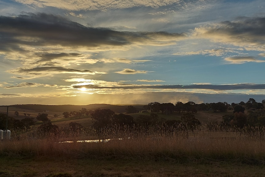 Sunrise and dust rises off the mine in central west NSW