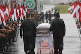 A guard of honour is formed as caskets arrive in Chapeco, Brazil.